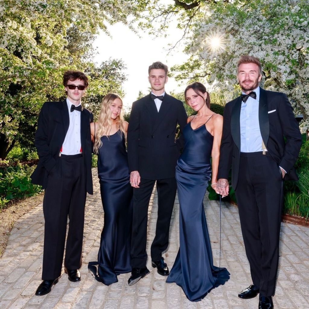 The Beckham family, including David, Victoria, Cruz, Romeo, and Harper, pose for a photo outdoors.