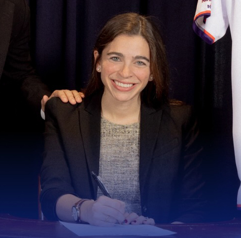 Emmy Liss signing a document.