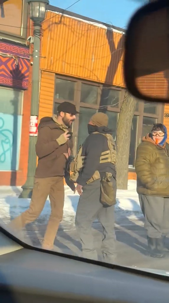 Alex Jeffrey Pretti speaking to an agent.