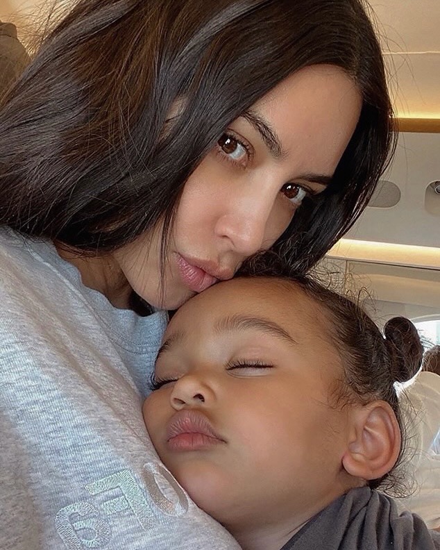Kim Kardashian holding a sleeping Chicago.