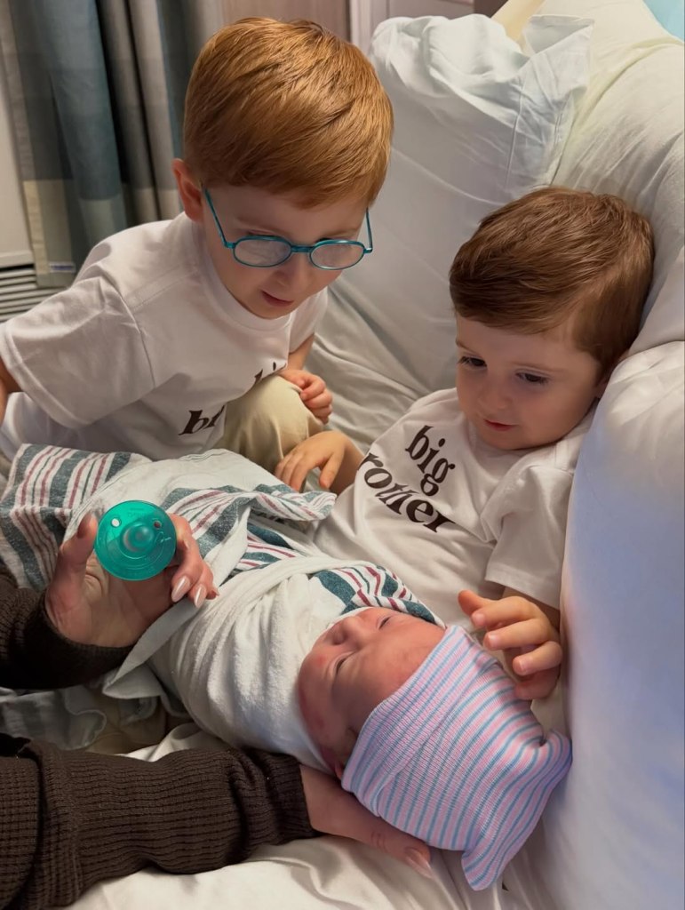 Meghan Trainor's sons look at their newborn sister.