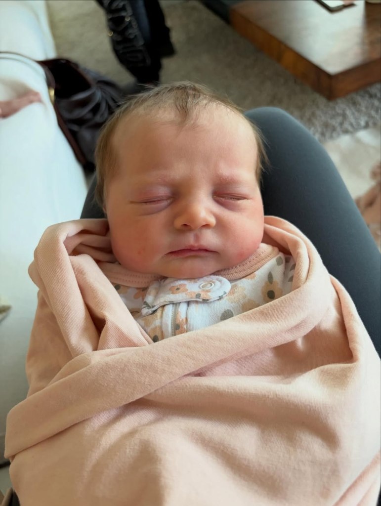 Meghan Trainor's newborn baby, wrapped in a pink blanket.