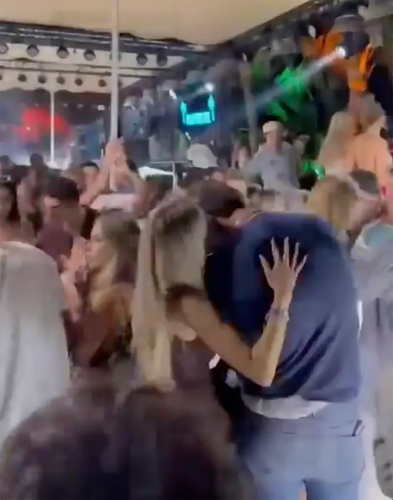 Alix Earle and Tom Brady embrace at a New Year's Eve party.