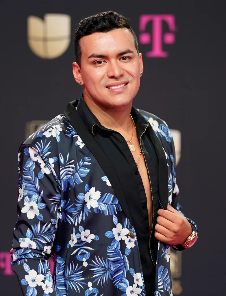 Yeison Jimenez in a blue and white floral patterned suit jacket.