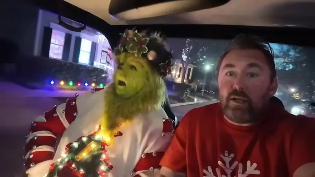 Adam the Woo with someone dressed as the Grinch at Disney World