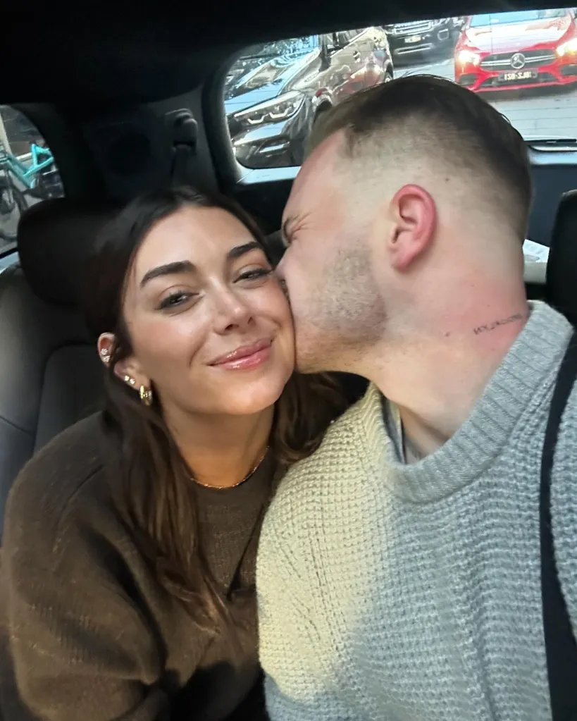 Zach Bryan kissing Brianna Chickenfry in a car.