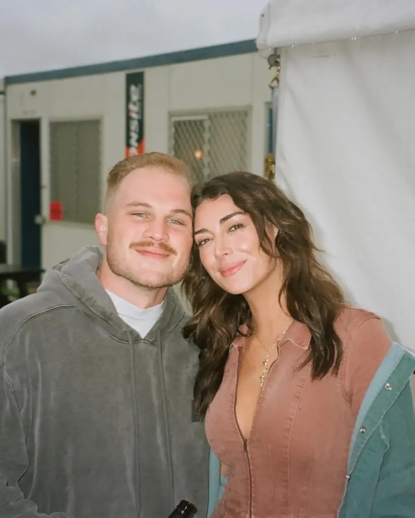 Zach Bryan and Brianna Chickenfry smiling.