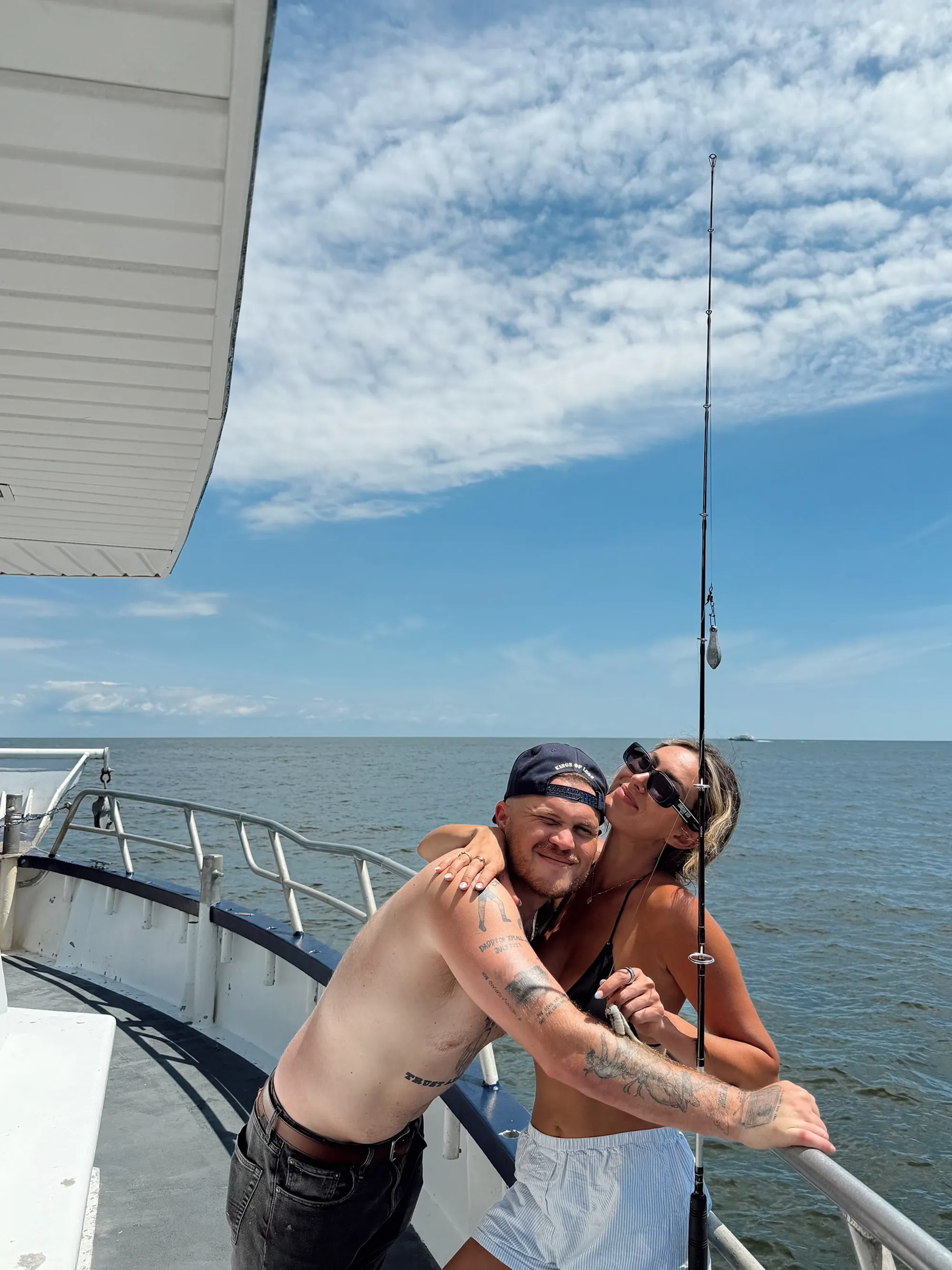 Zach Bryan and Samantha Leonard embrace on a boat.