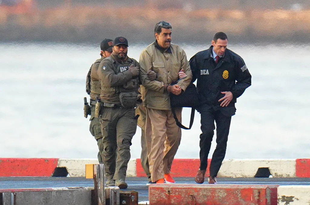 Nicolas Maduro is escorted by DEA agents.