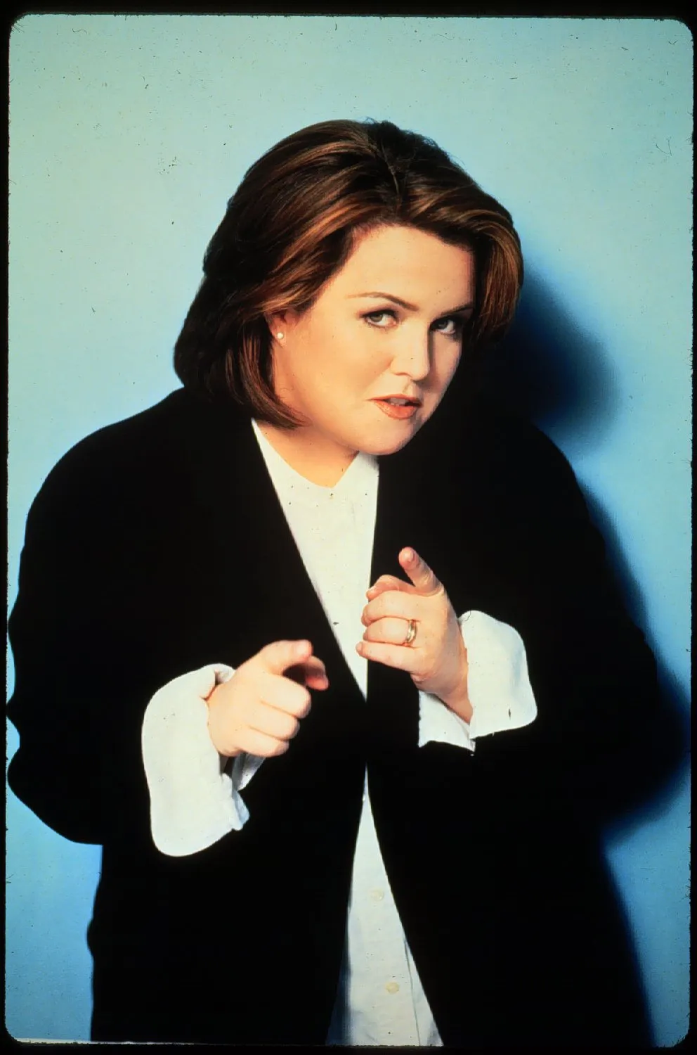Rosie O'Donnell pointing at the viewer.