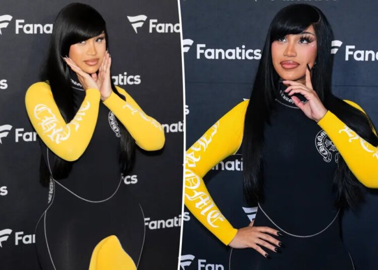 Cardi B takes a tumble while giving a robot a lap dance