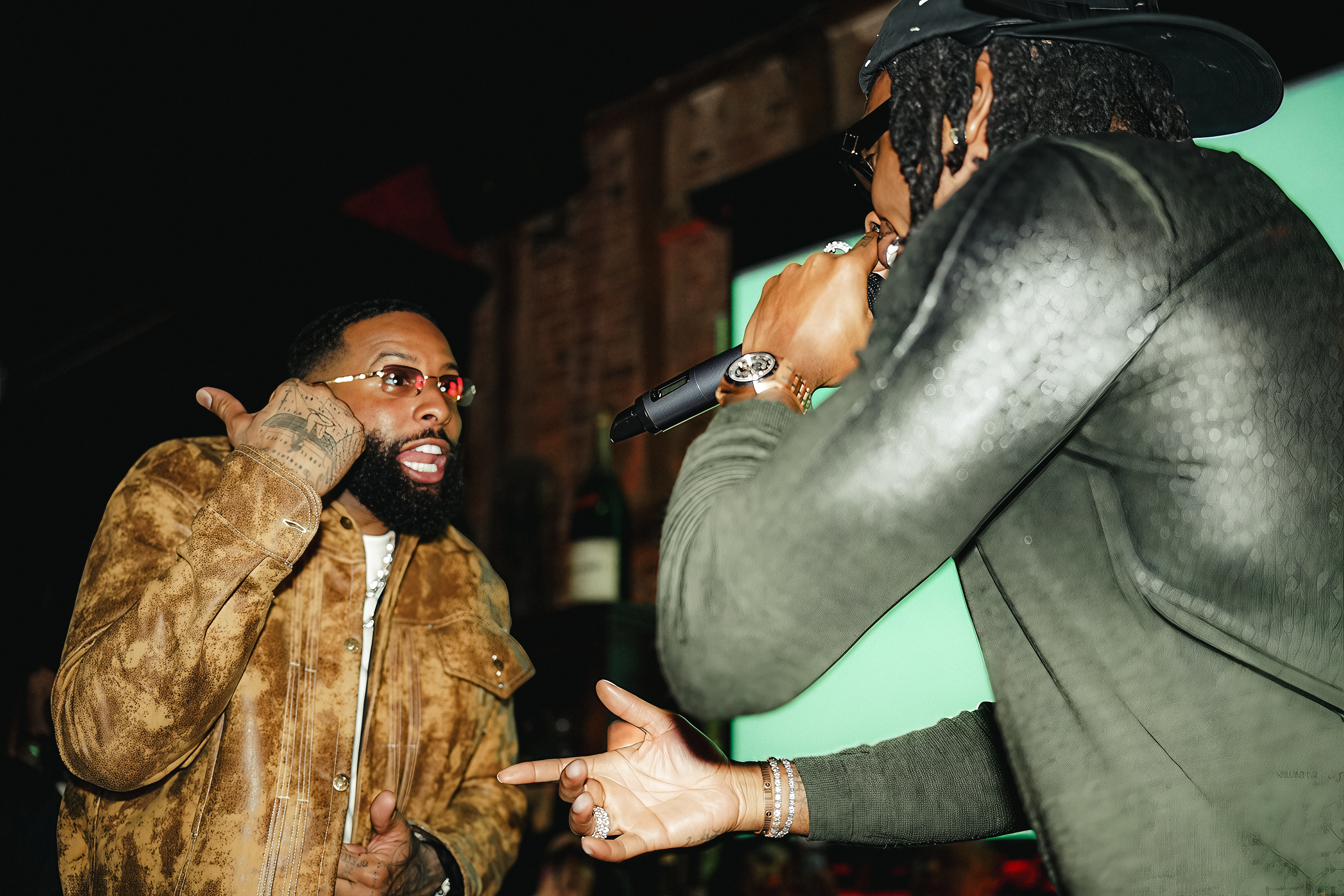 Odell Beckham Jr. performs on stage with a rapper.