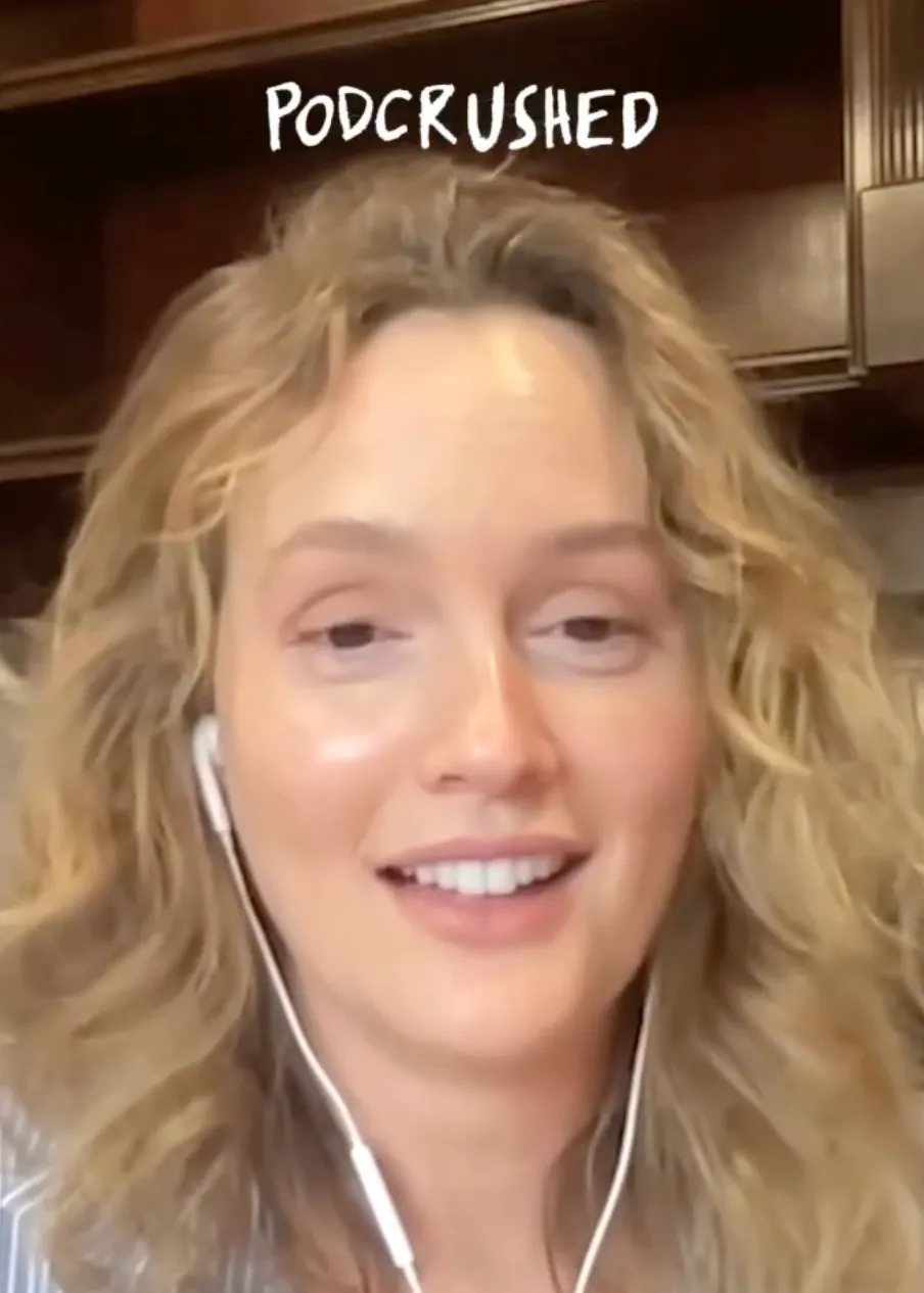 Leighton Meester wearing earbuds, smiling during her 