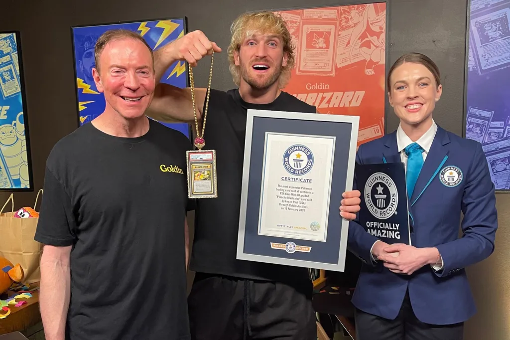 Logan Paul and two Goldin Auctions representatives holding up the Guinness World Record certificate for the most expensive Pokémon card.