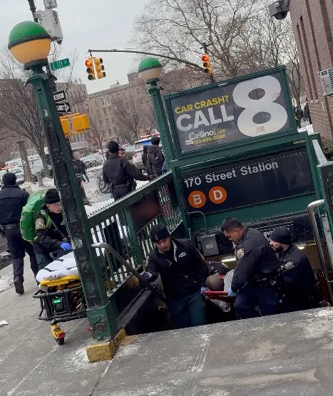 First responders carrying a shooting victim out of the 170th Street subway station.