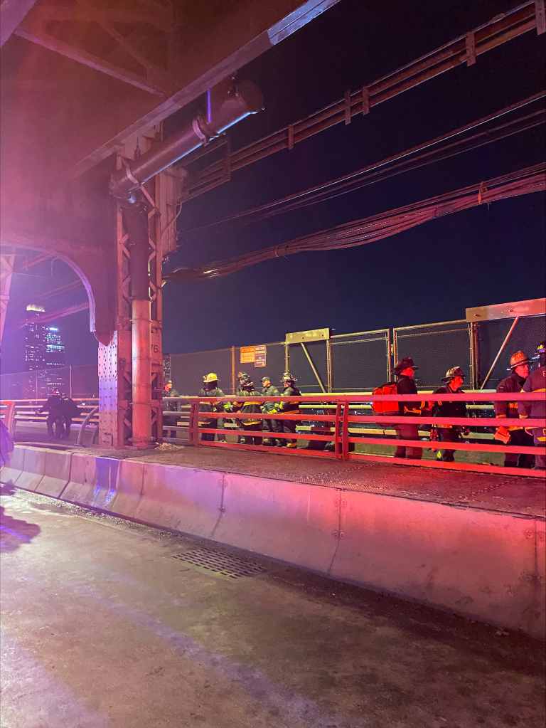 Firefighters on the Ed Koch Queensboro Bridge after a rescue operation.