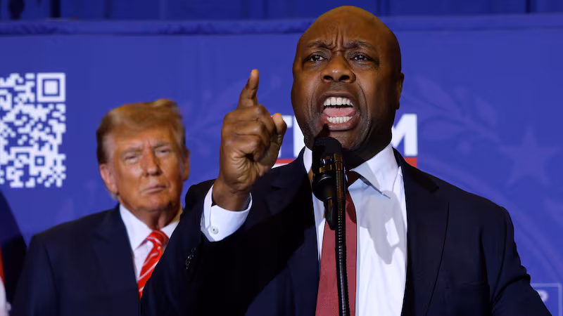 Sen. Tim Scott speaks as President Donald Trump looks on during a campaign rally at the Grappone Convention Center on January 19, 2024 in Concord, New Hampshire