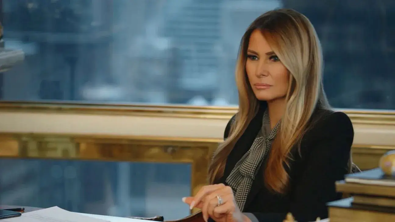 Melania Trump sitting at a desk