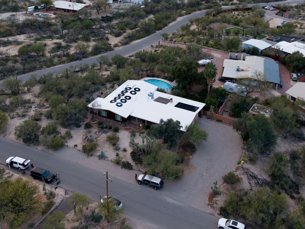 Aerial view of Annie Guthrie and Tommaso Cioni's home in Tucson, Arizona, surrounded by desert landscaping and roads.
