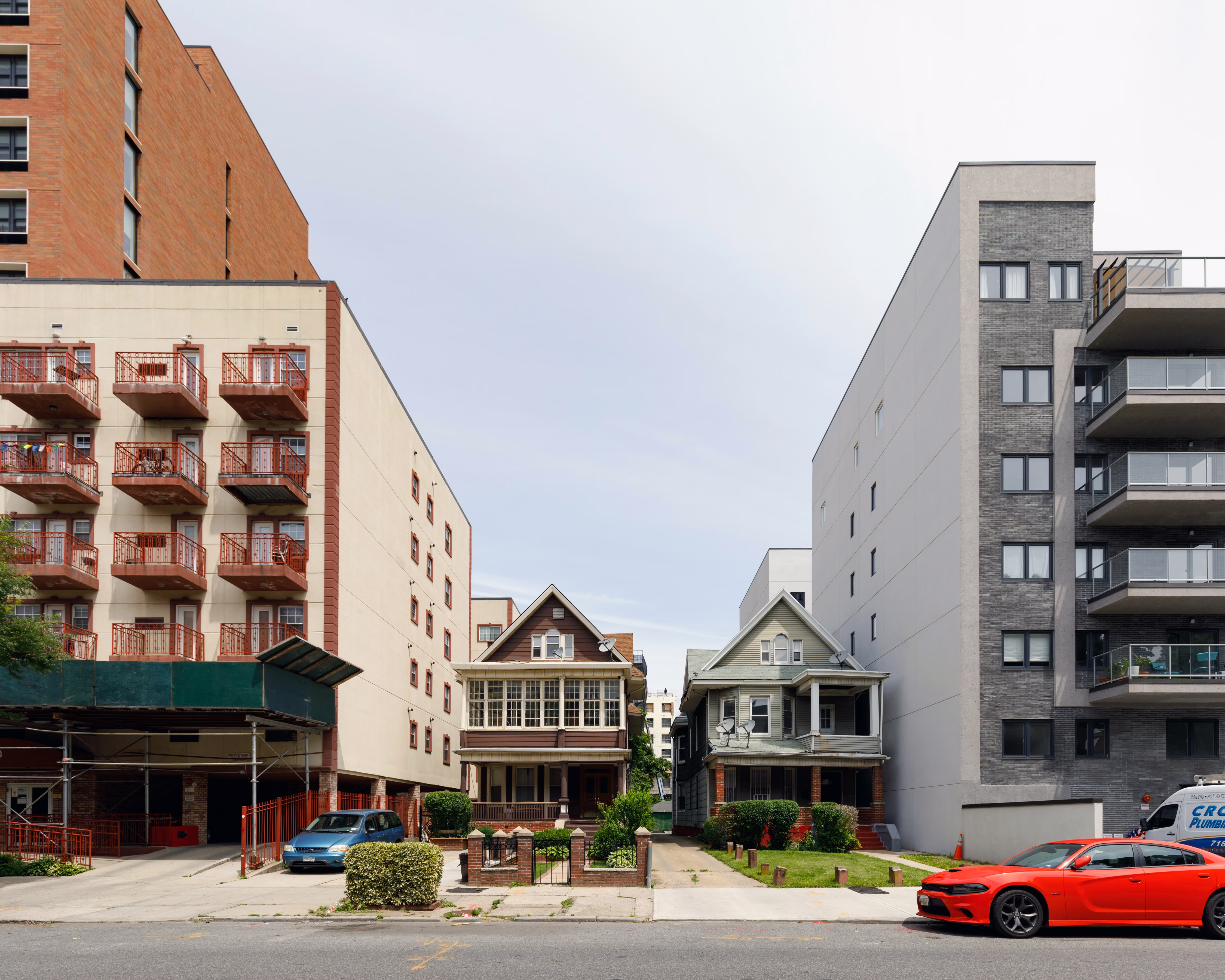 two single family homes between mid-rise condo buildings in flatbush