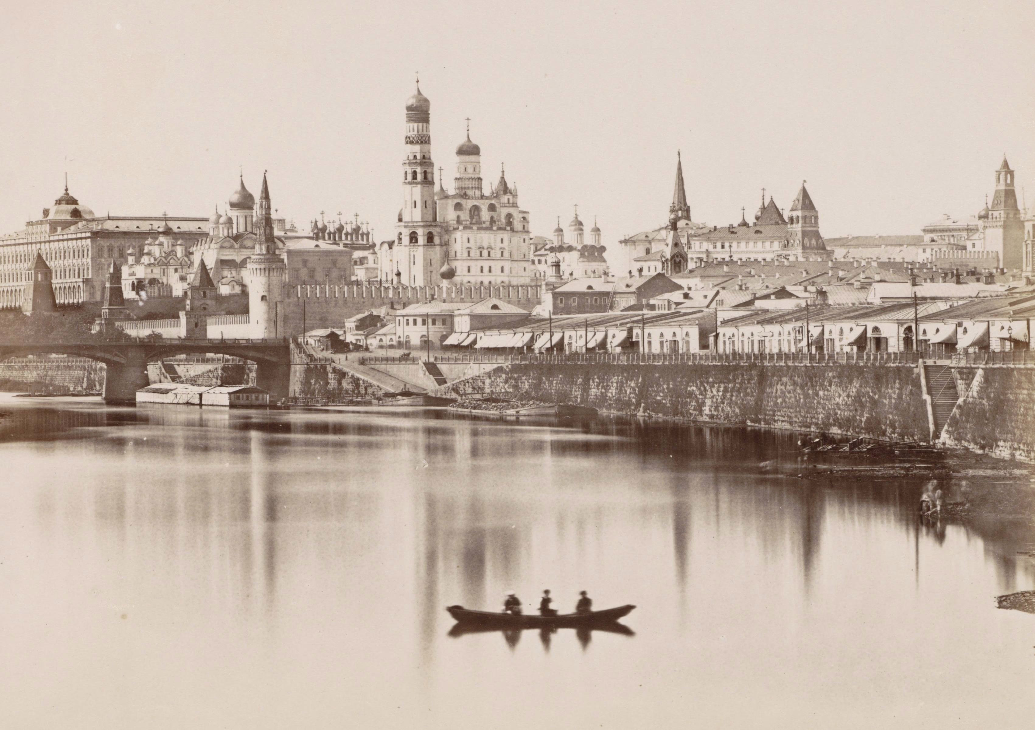 The many historic buildings of Moscow's Kremlin, seen from across a river.
