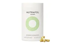 A canister of Nutrafol and pills.