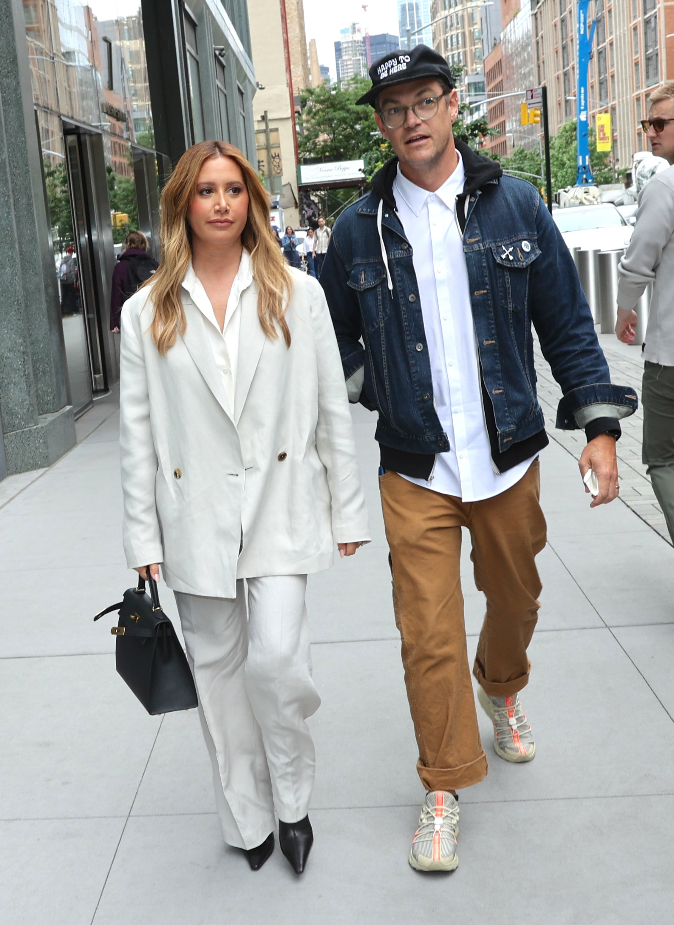 Ashley Tisdale and Christopher French walking down a city street.