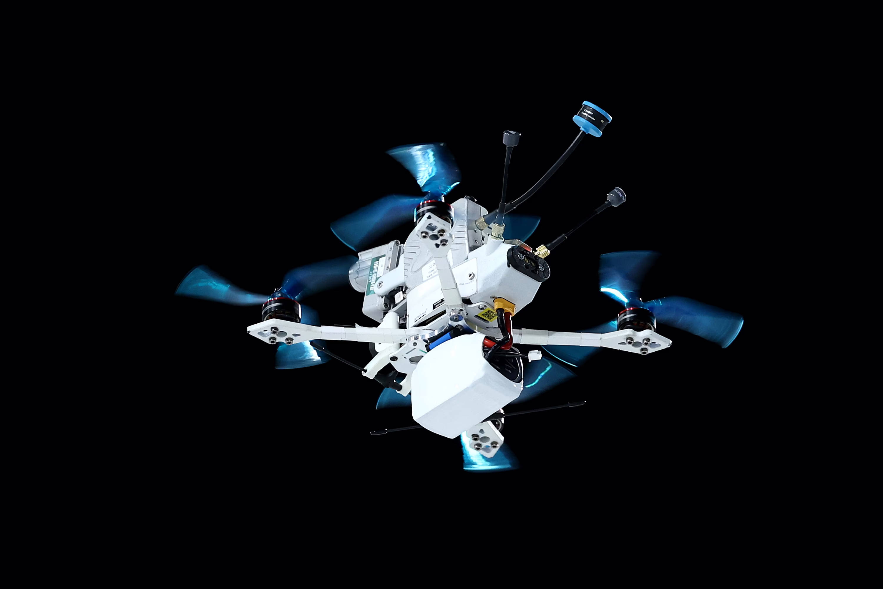 A complex four-propeller camera drone flies overhead.