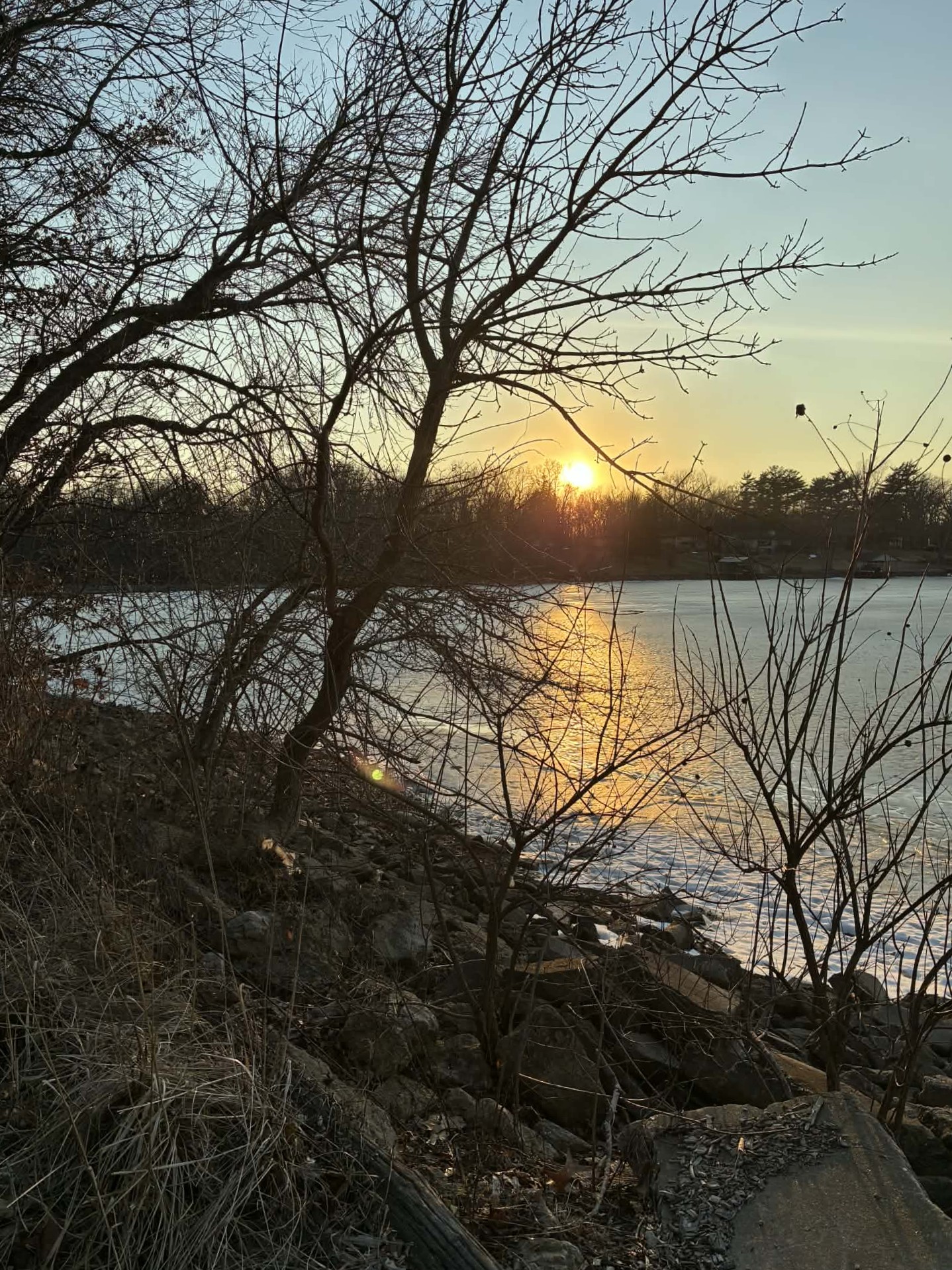 A lake with a setting sun over it