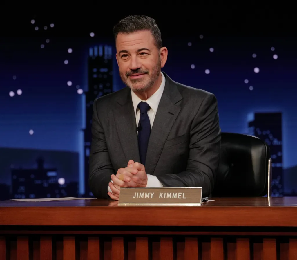 Jimmy Kimmel sitting at his desk.