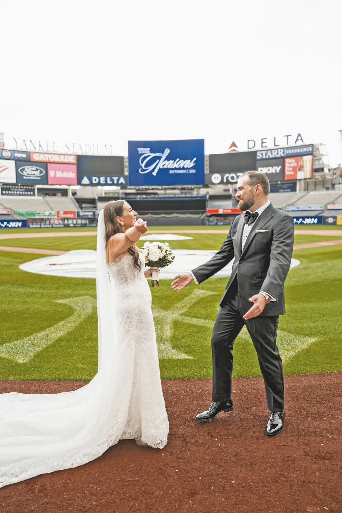 A bride and groom on the baseball field of Yankee Stadium.