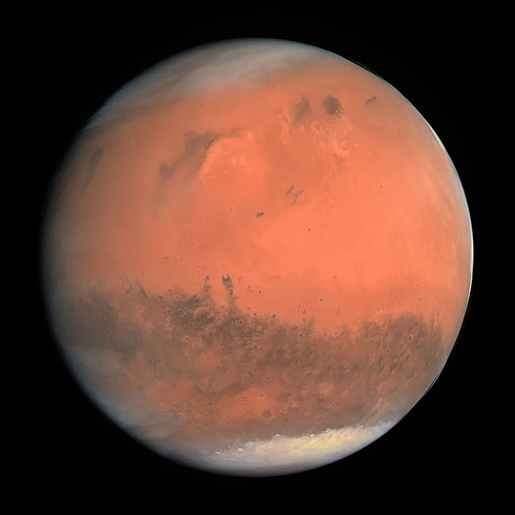 Mars appears as a red and brown planet with some white cloud cover against a black background.