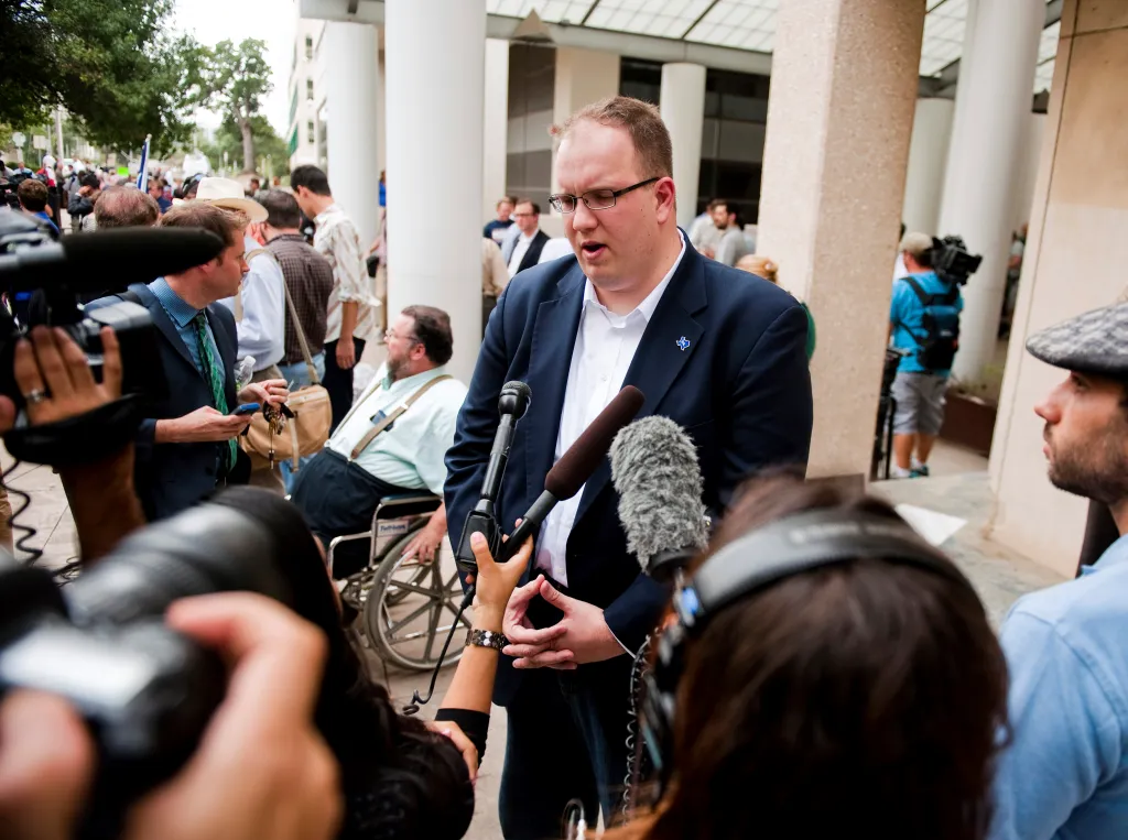 Will Hailer, executive director of the Texas Democrats, speaks opposing Governor Rick Perry at the Travis County courthouse in Austin, Texas.