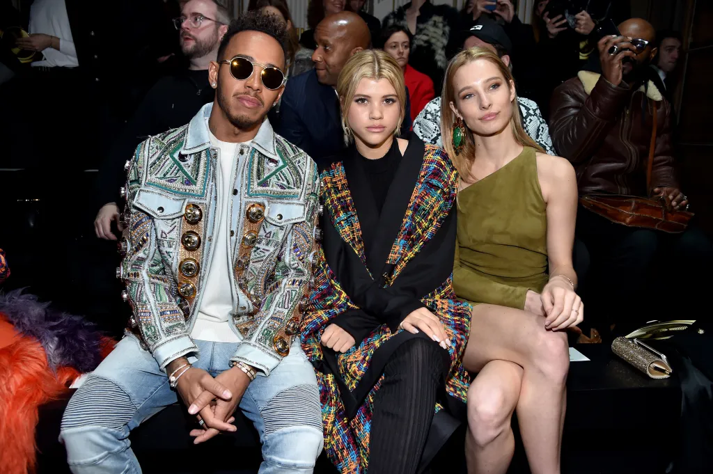 Lewis Hamilton, Sofia Richie, and Ilona Smet seated at the Balmain Menswear Fall/Winter 2017-2018 show.