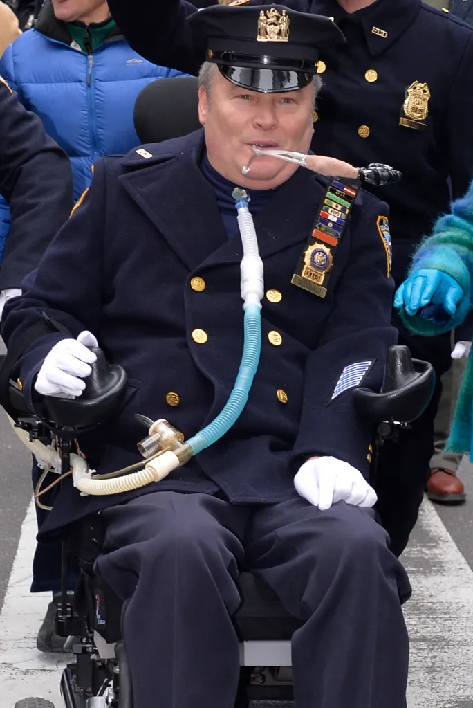 Detective Steven D. McDonald in a wheelchair, wearing a police uniform and a breathing tube.