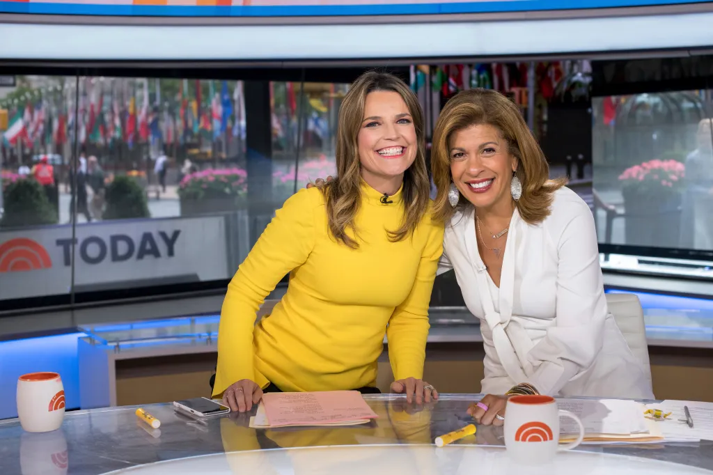 Savannah Guthrie and Hoda Kotb smiling on the Today show set.