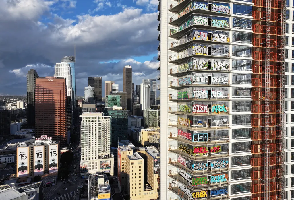 Aerial view of an unfinished skyscraper in Los Angeles covered in graffiti.