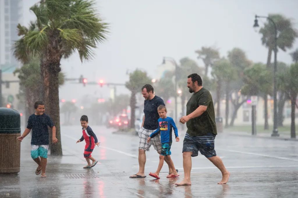 People walking in the rain during Hurricane Isaias.