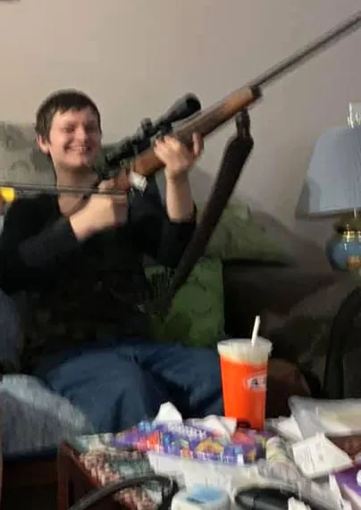 Jesse Strang holding a rifle.