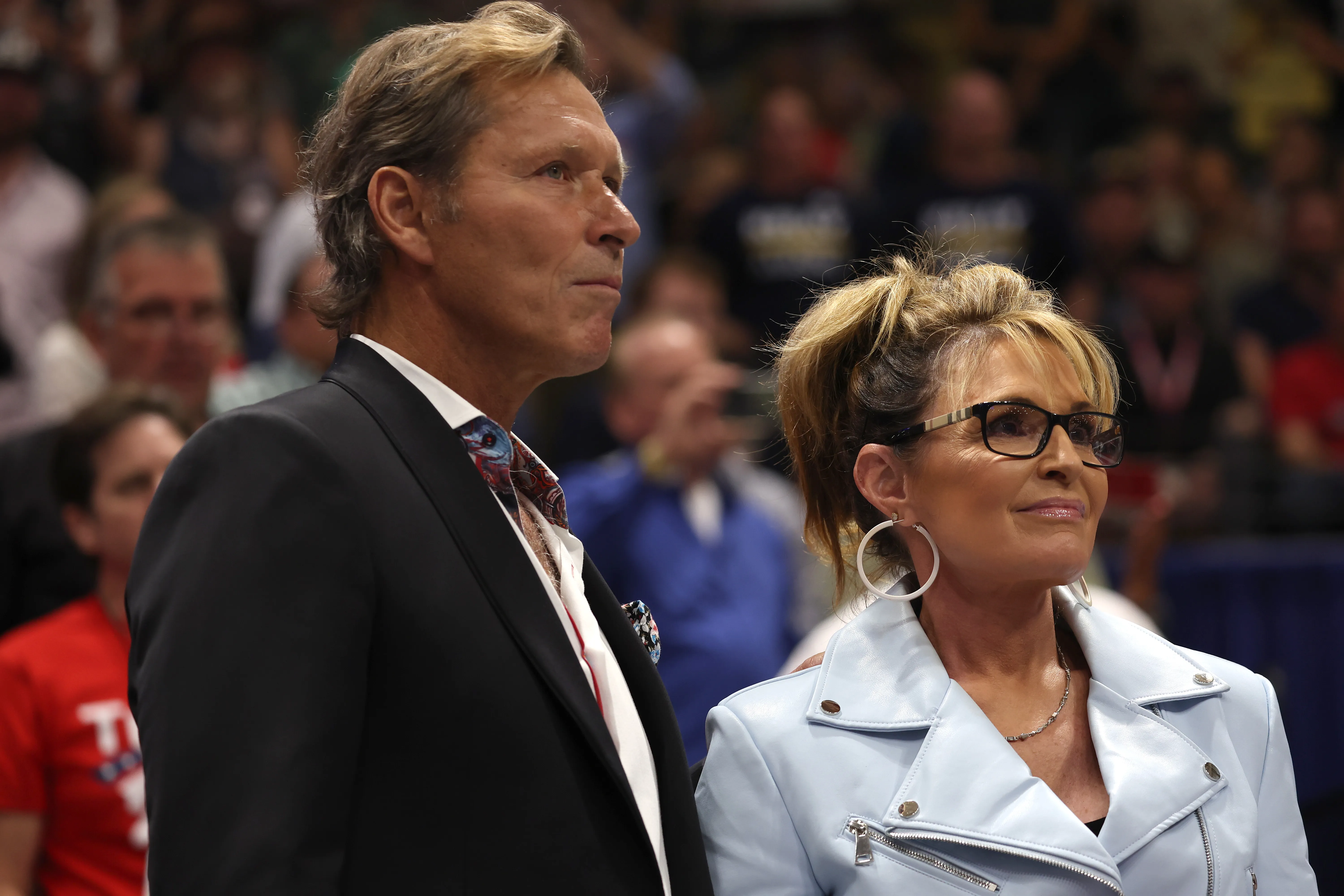 Ron Duguay and Sarah Palin standing together at a rally.