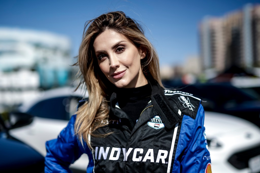 Ellina Abovian smiling in an IndyCar jacket.