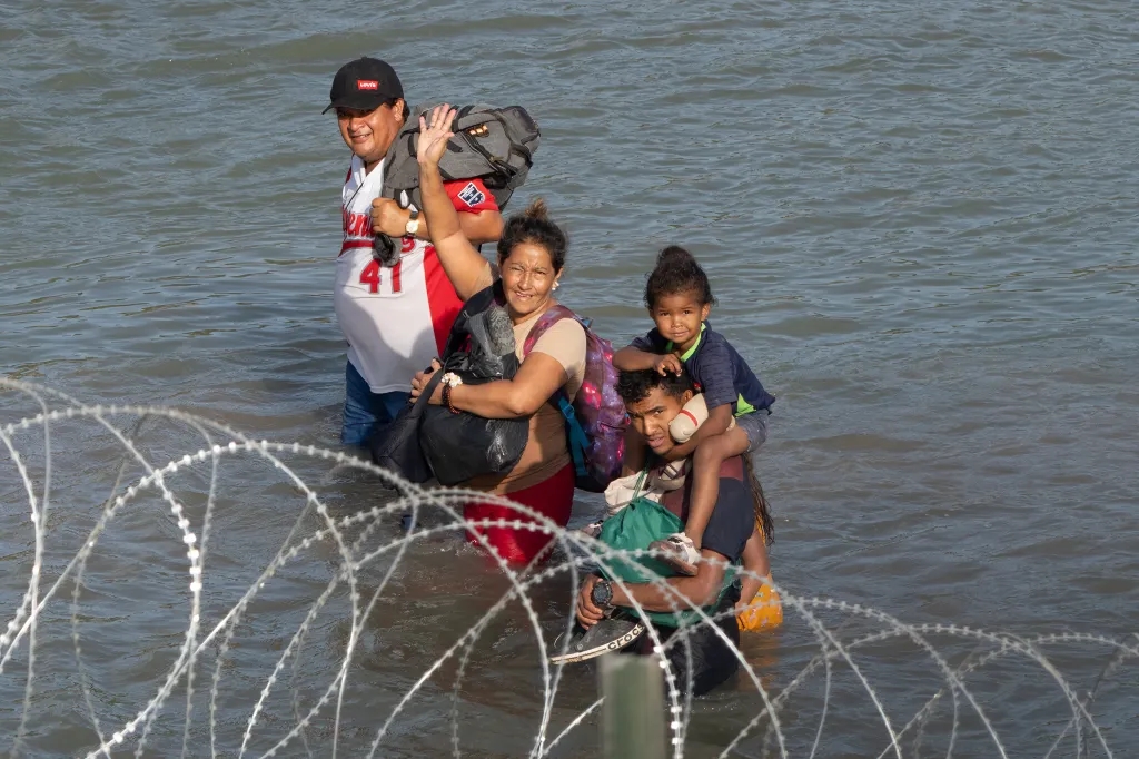 Migrants cross the Rio Grande between the US-Mexico border into Eagle Pass, Texas on July 16, 2023.