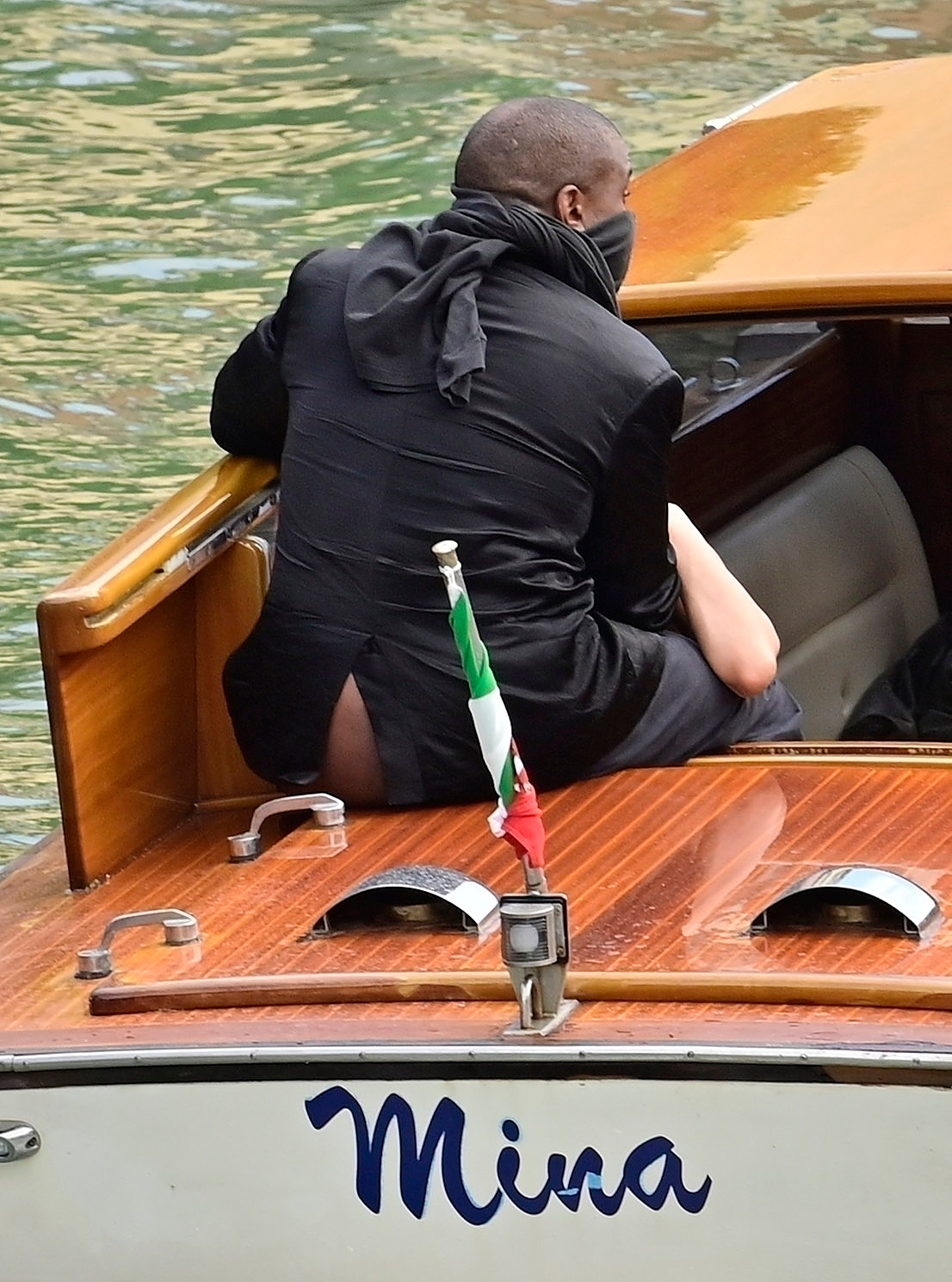 Kanye West exposes his buttocks while riding on a water taxi in Venice.