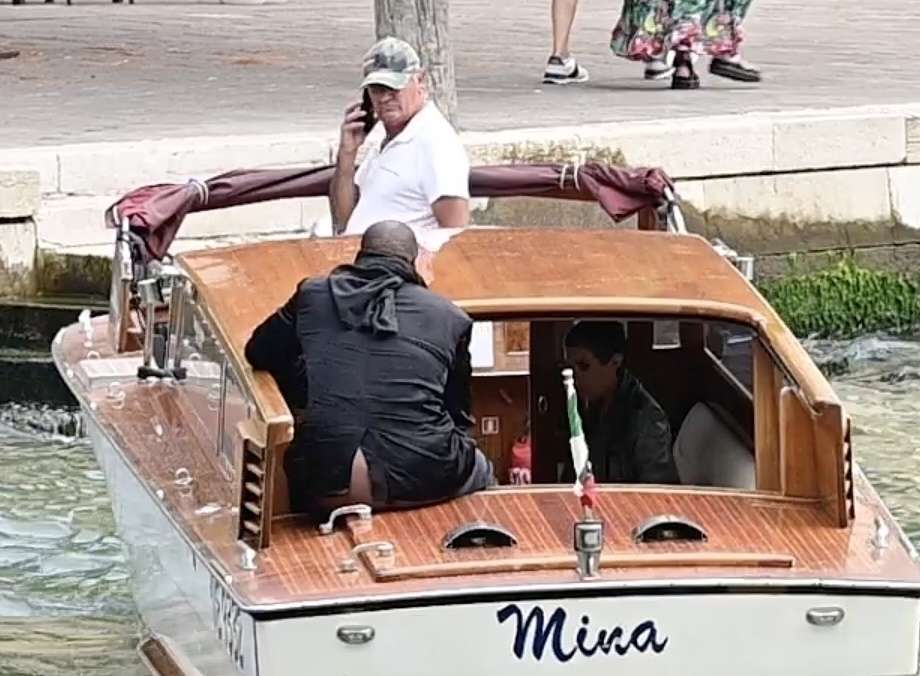 Kanye West sitting with his bare bottom exposed on a water taxi in Venice.