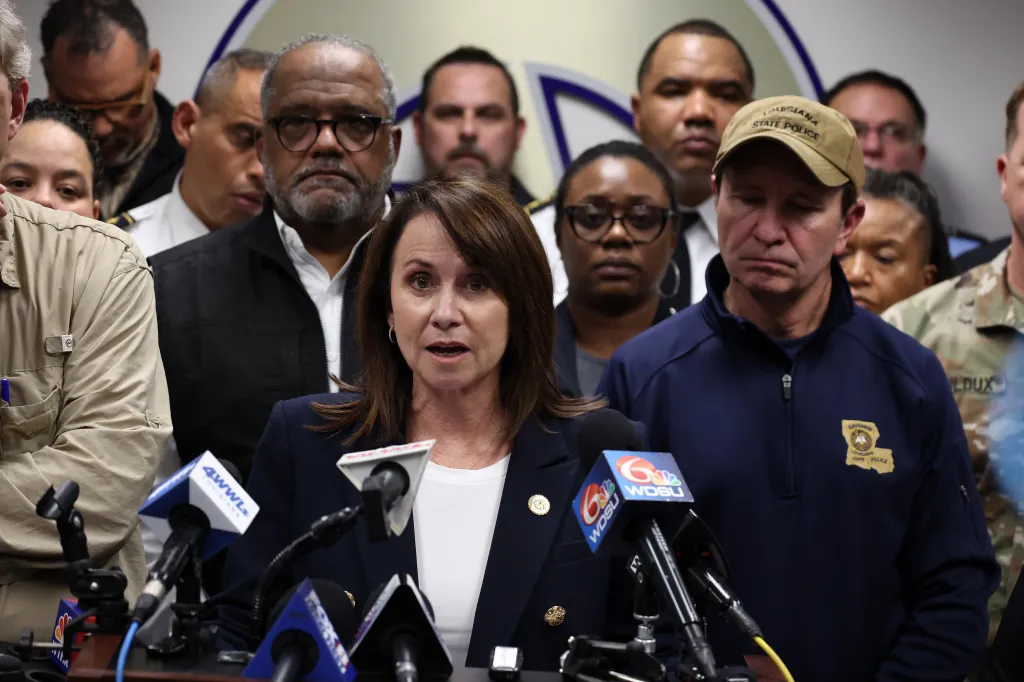 Louisiana Attorney General Liz Murrill speaks to the media with other officials in the background.