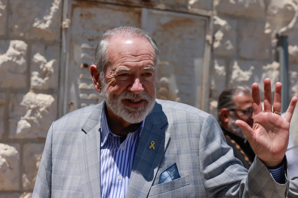 US Ambassador Mike Huckabee waving to people in the Palestinian Christian village of Taybeh.