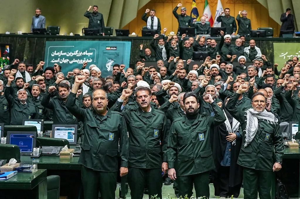 Iranian parliament members dressed in IRGC uniforms chant 