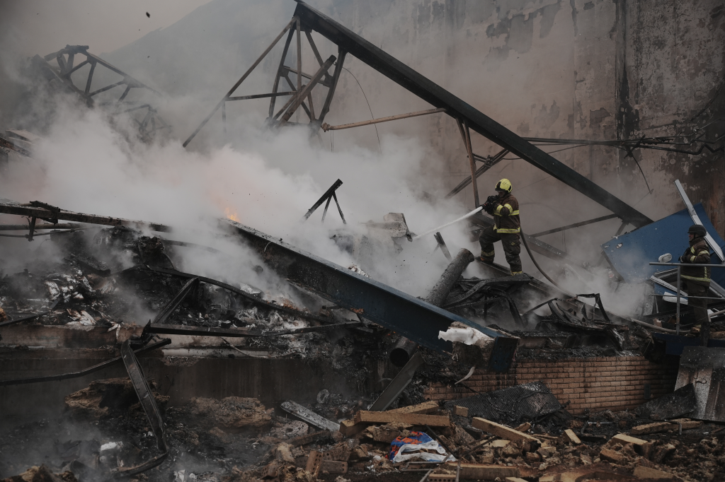 Rescue workers extinguish a fire at an American-owned factory in Kharkiv after a Russian missile strike.