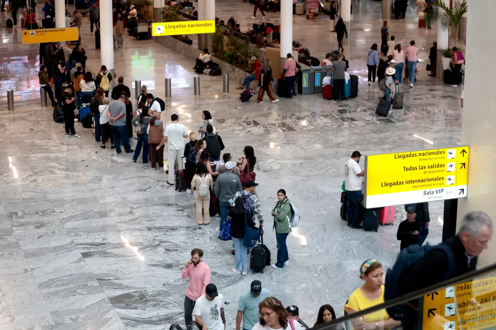 Passengers waiting in line at Guadalajara International Airport.