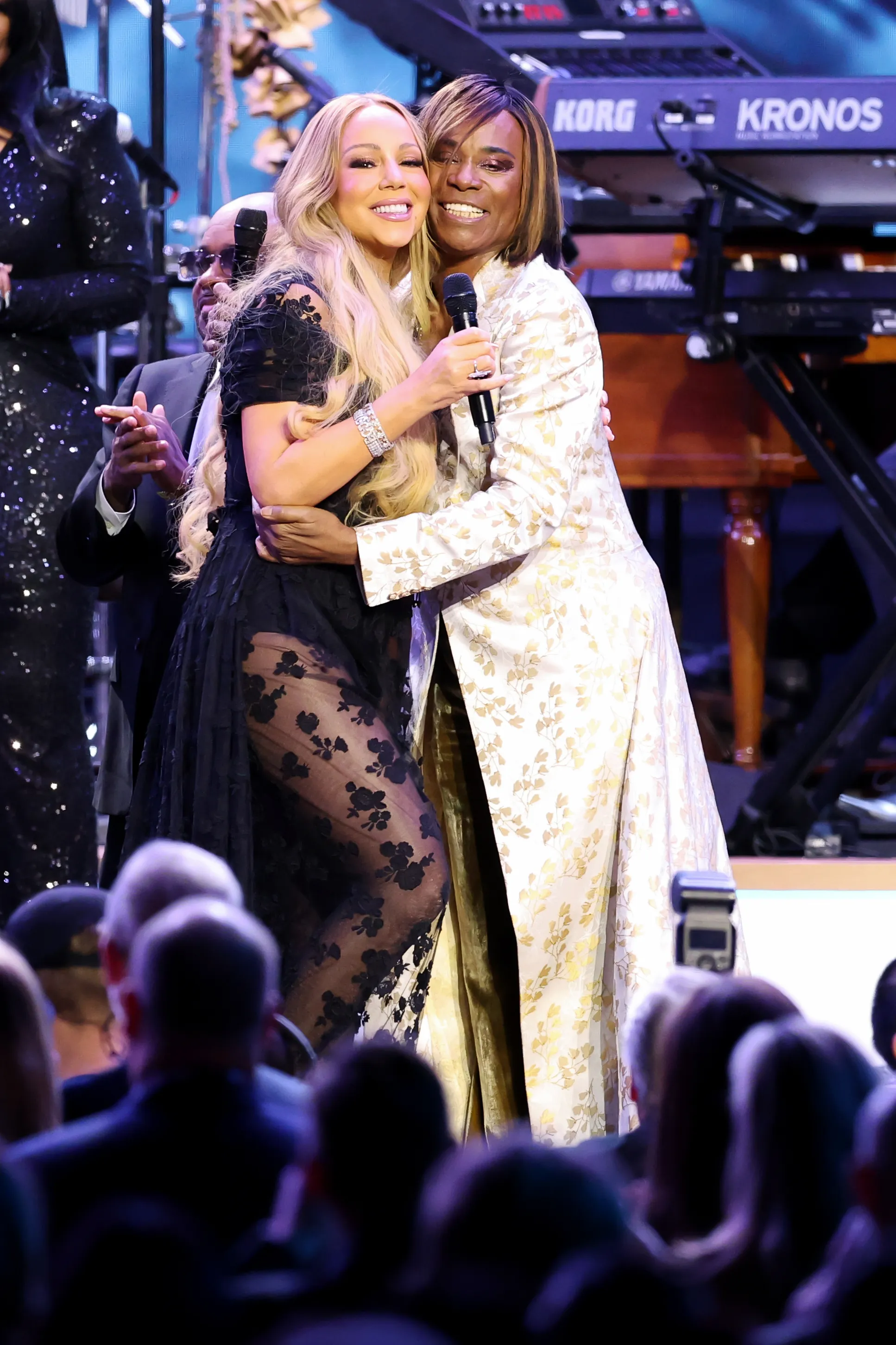 Mariah Carey embracing Billy Porter onstage.